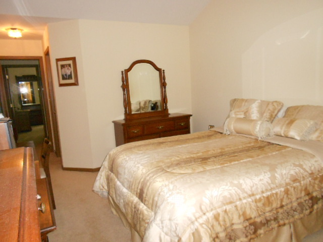 454 Prairieview Drive Oswego, IL 60543 - Photo 9 of 14 a bedroom with a bed and a dresser