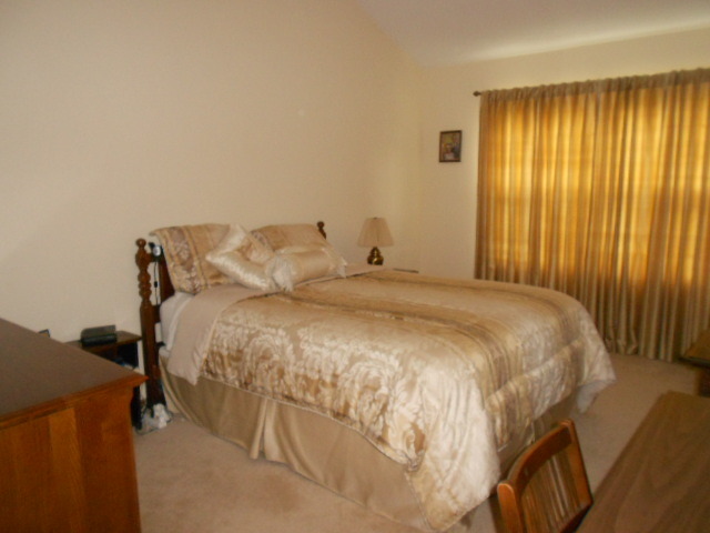 454 Prairieview Drive Oswego, IL 60543 - Photo 10 of 14 a large bed sitting in a spacious bedroom next to a window