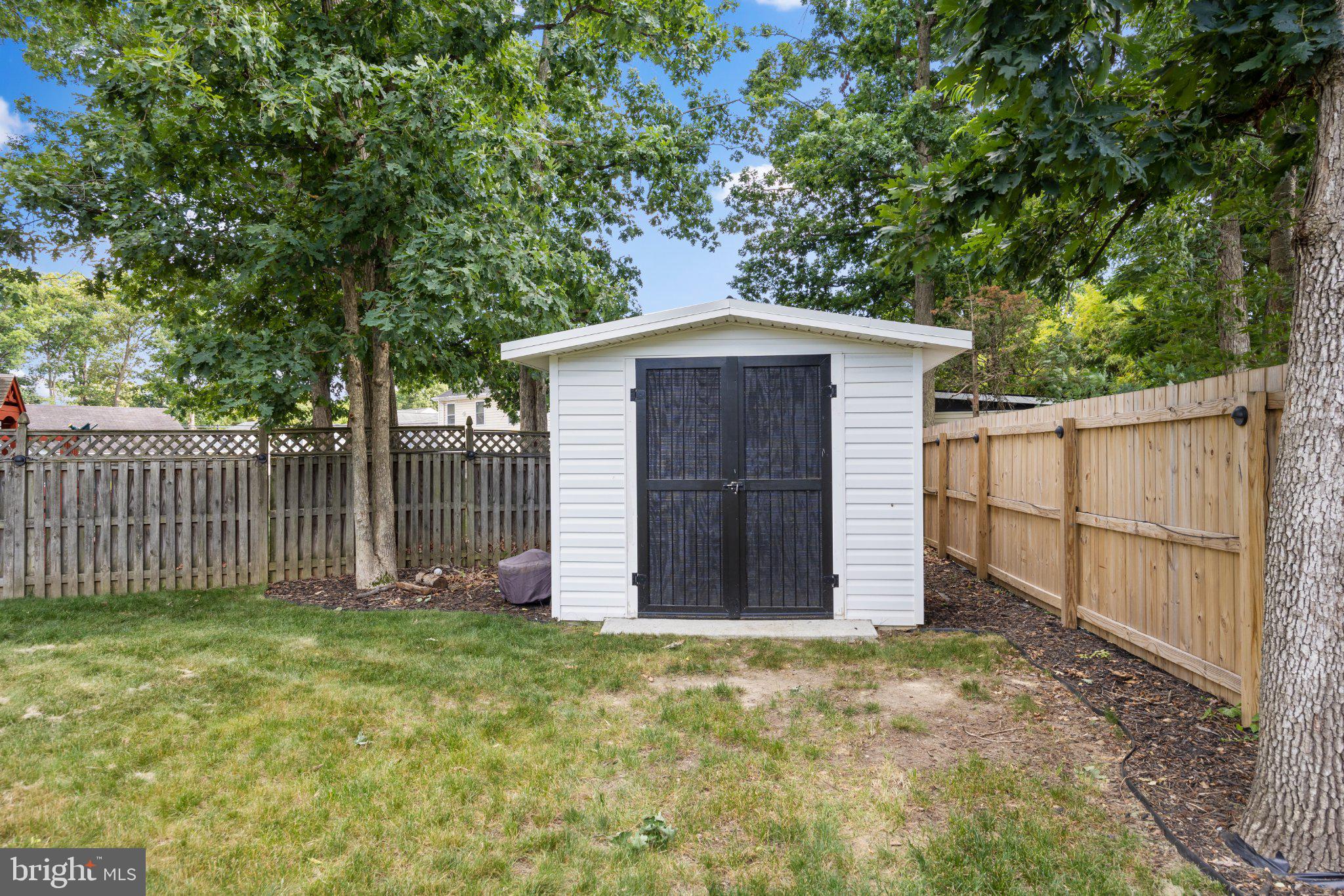 6705 New Hope Drive Springfield, VA 22151 - Photo 55 of 67 Charming shed nestled in a green yard.