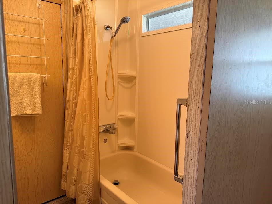 5168 Rubber Tree Circle New Port Richey, FL 34653 - Photo 12 of 36 a bathroom with a shower