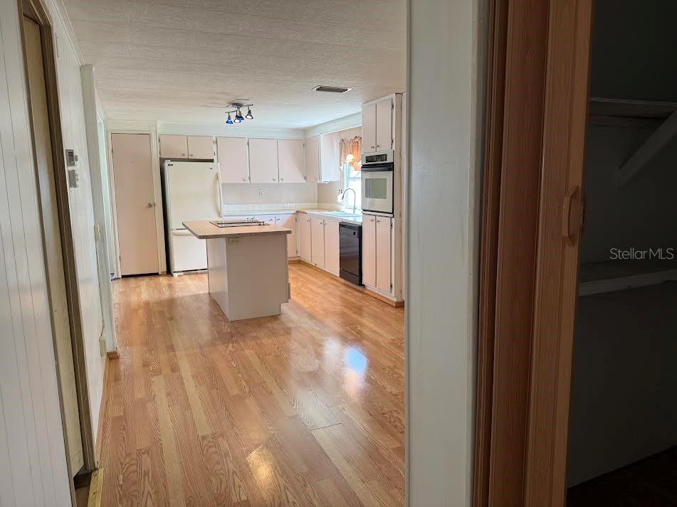 5168 Rubber Tree Circle New Port Richey, FL 34653 - Photo 16 of 36 a view of a kitchen with wooden floor