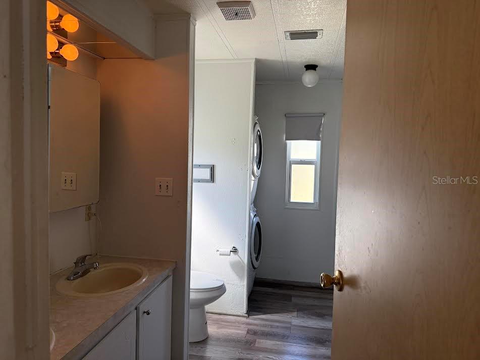 5168 Rubber Tree Circle New Port Richey, FL 34653 - Photo 19 of 36 a bathroom with a granite countertop toilet sink and mirror