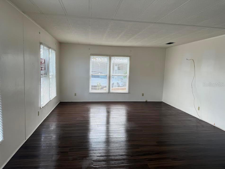 5168 Rubber Tree Circle New Port Richey, FL 34653 - Photo 2 of 36 an empty room with wooden floor and windows
