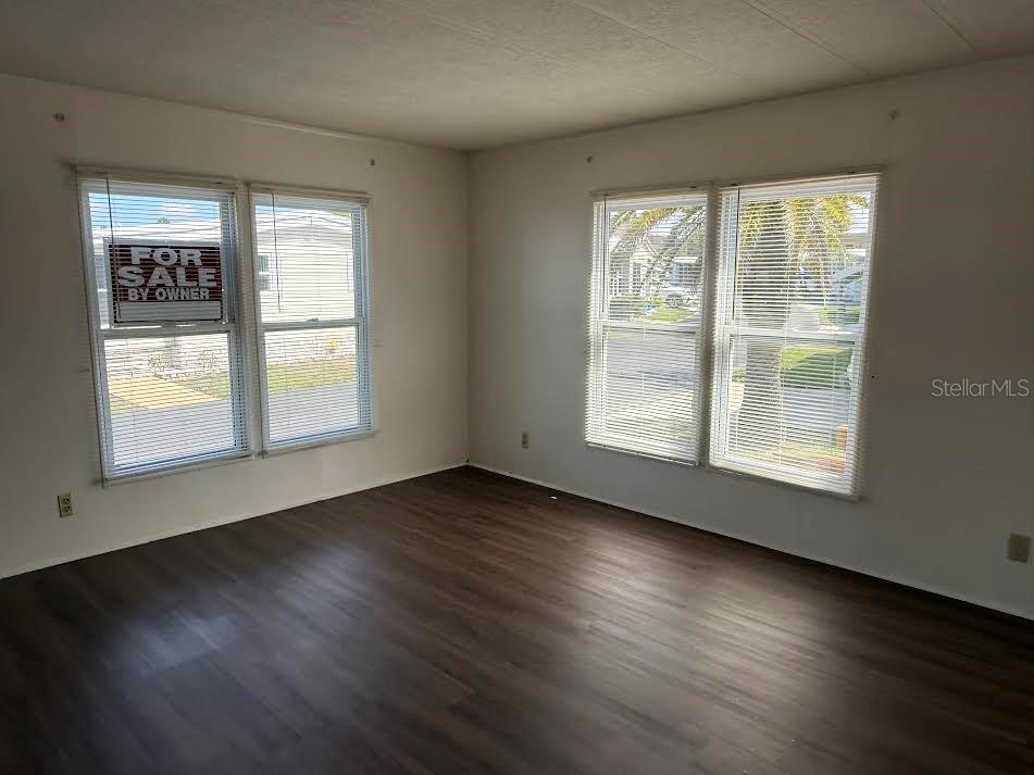 5168 Rubber Tree Circle New Port Richey, FL 34653 - Photo 24 of 36 a view of an empty room with wooden floor and a window