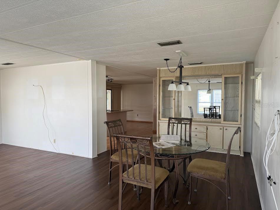 5168 Rubber Tree Circle New Port Richey, FL 34653 - Photo 26 of 36 a view of a dining room with furniture and wooden floor