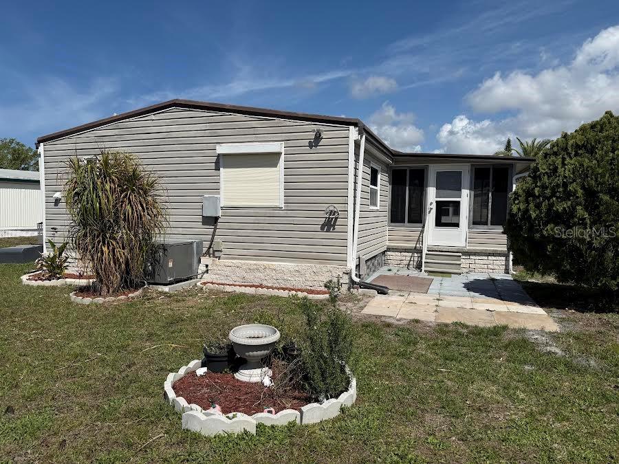 5168 Rubber Tree Circle New Port Richey, FL 34653 - Photo 29 of 36 a backyard of a house with yard fire pit and furniture