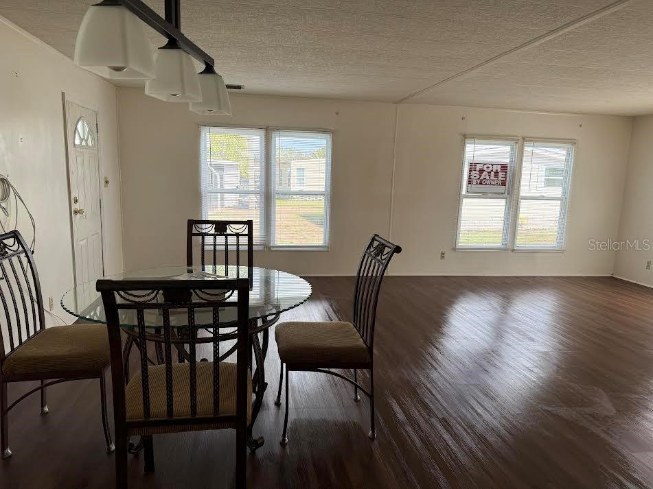 5168 Rubber Tree Circle New Port Richey, FL 34653 - Photo 4 of 36 a view of a dining room with furniture window and wooden floor