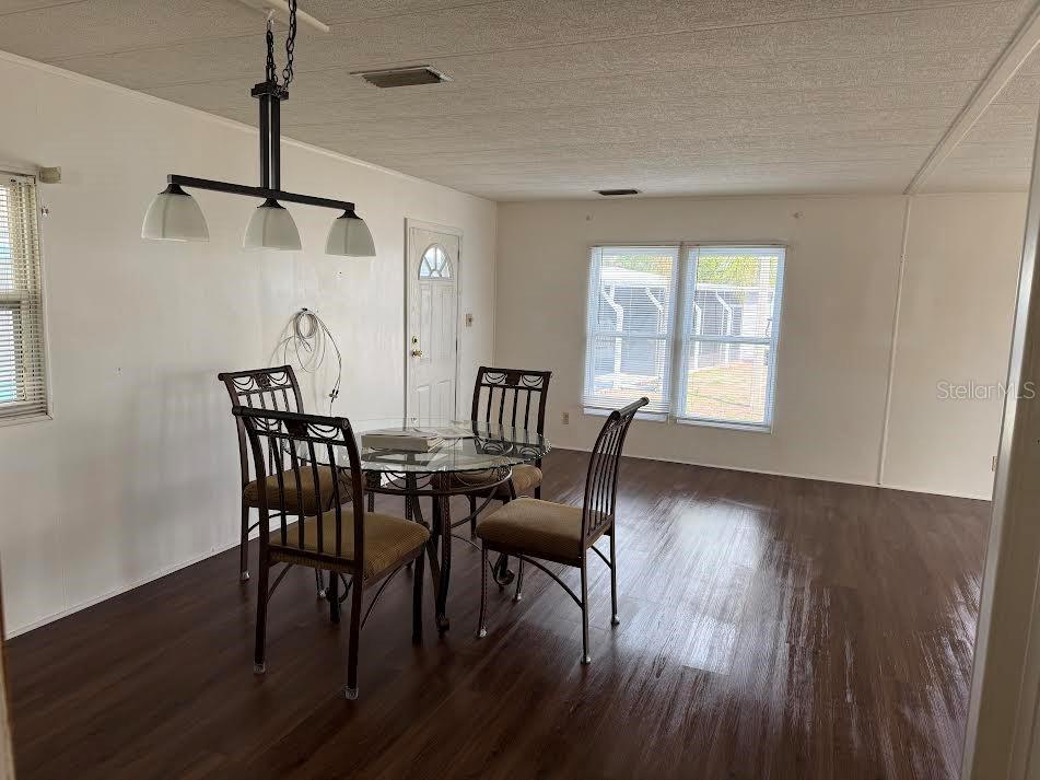 5168 Rubber Tree Circle New Port Richey, FL 34653 - Photo 5 of 36 a view of a dining room with furniture window and wooden floor