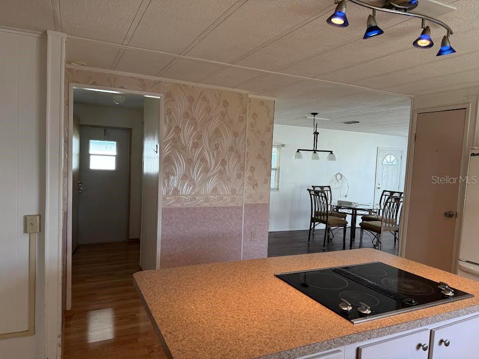5168 Rubber Tree Circle New Port Richey, FL 34653 - Photo 8 of 36 a kitchen with a sink and chairs