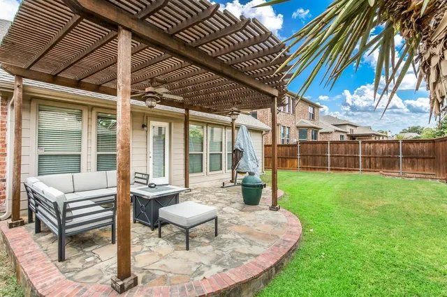 a view of a house with backyard sitting area and garden