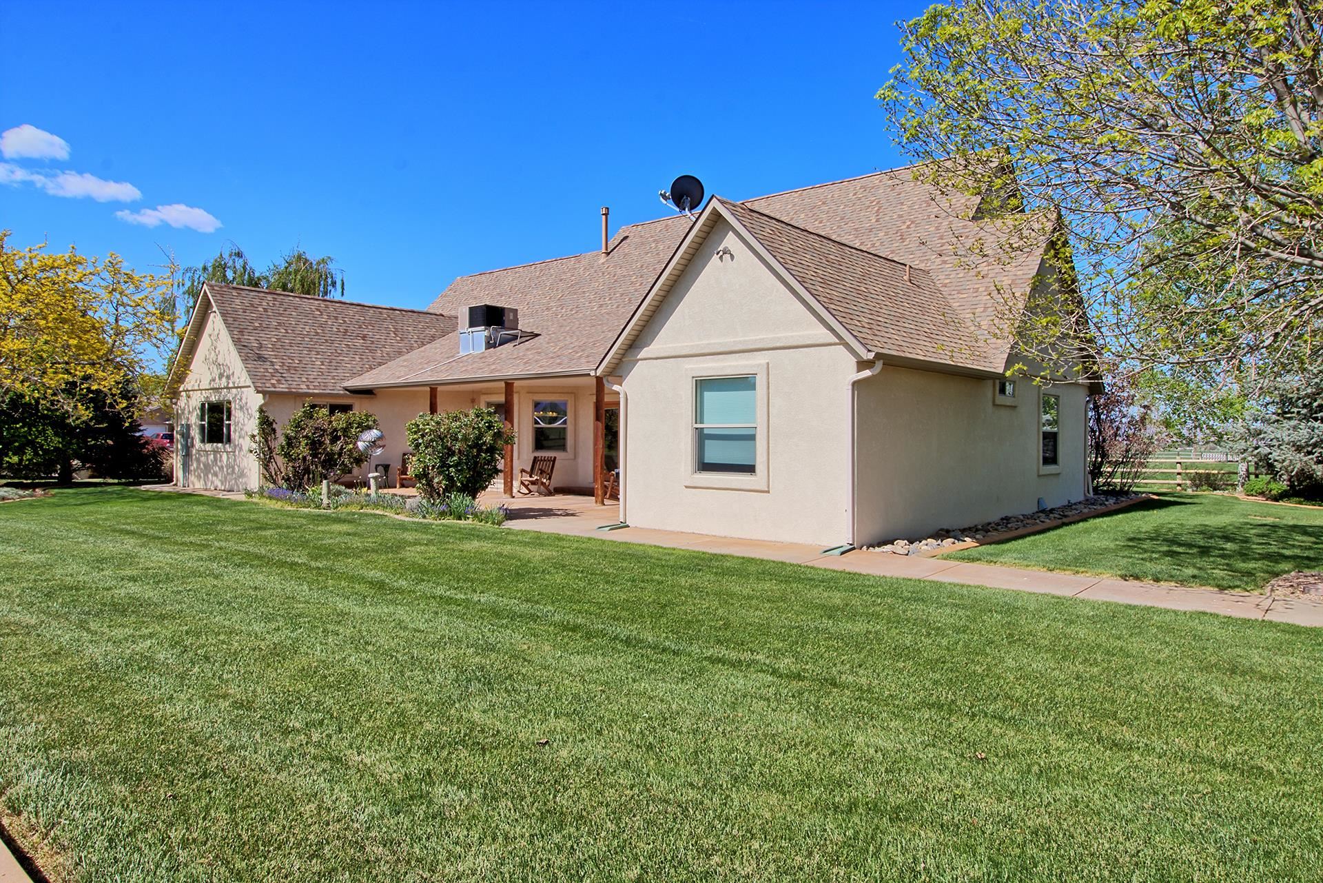 2302 Outback Ridge Road Grand Junction, CO 81505 - Photo 13 of 42 a view of a house with a yard