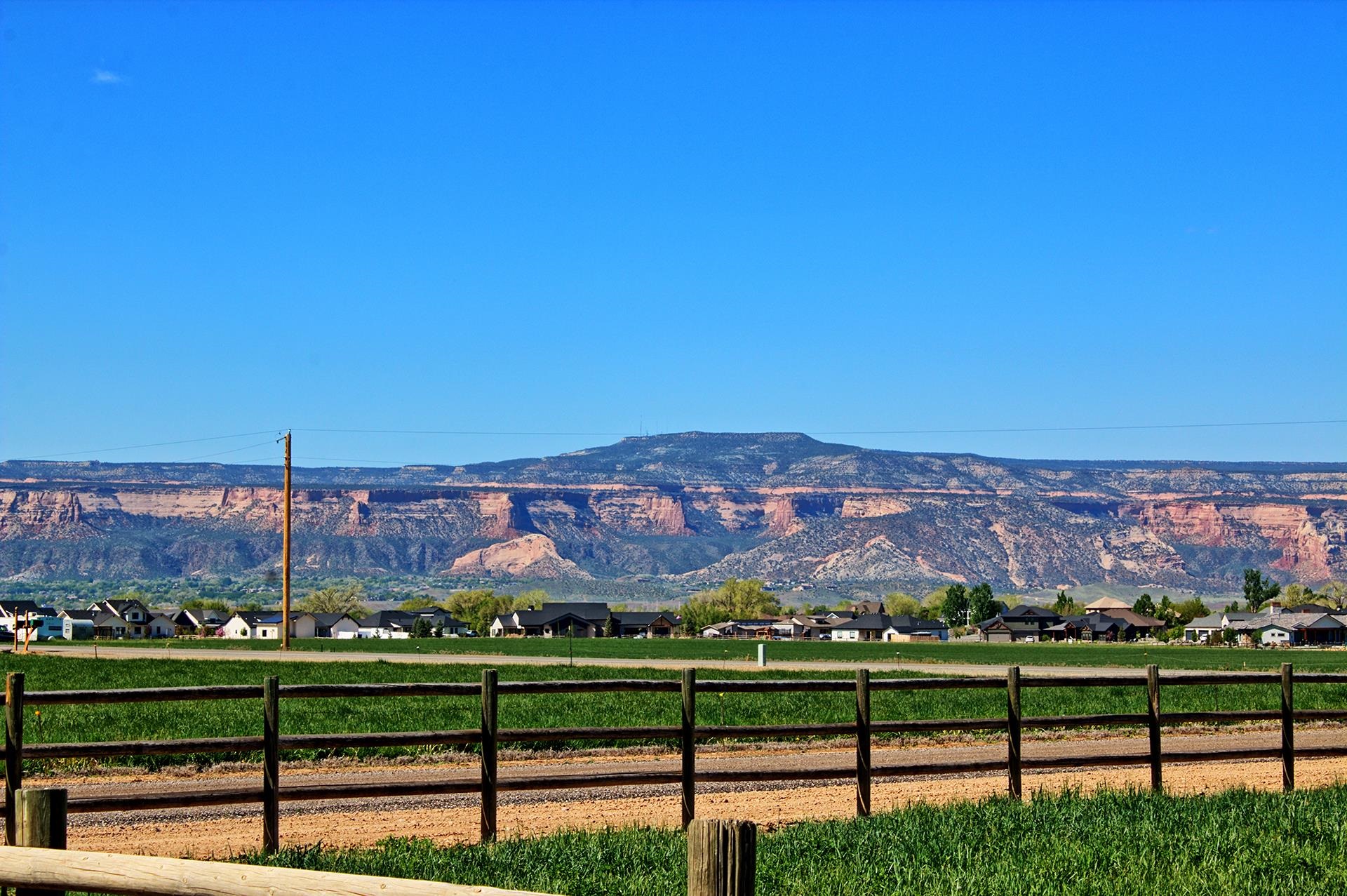 2302 Outback Ridge Road Grand Junction, CO 81505 - Photo 17 of 42 a view of a city with a building in the background