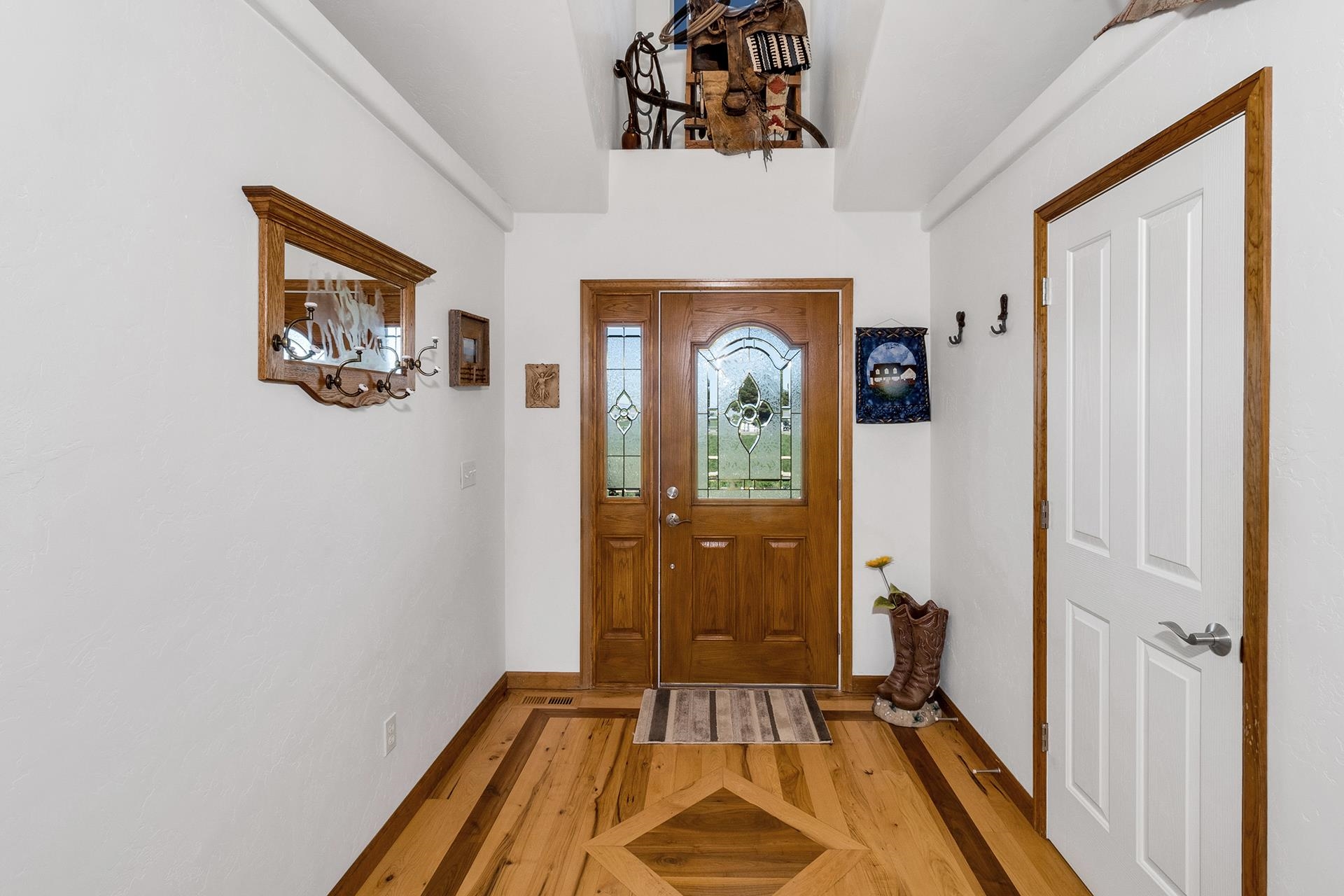 2302 Outback Ridge Road Grand Junction, CO 81505 - Photo 19 of 42 a view of a hallway with wooden floor and closet
