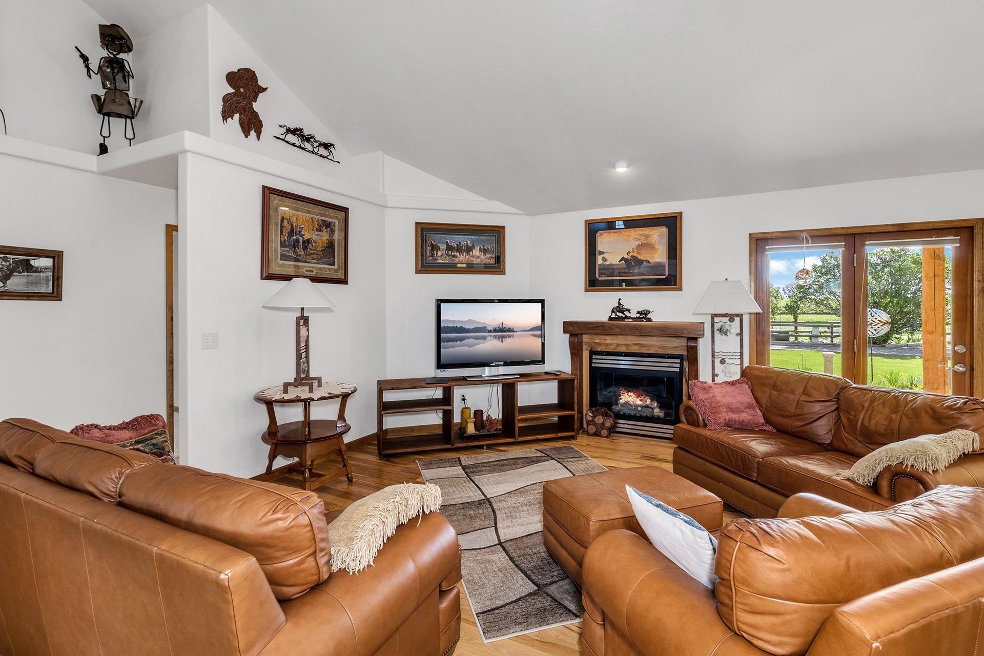 2302 Outback Ridge Road Grand Junction, CO 81505 - Photo 20 of 42 a living room with furniture a flat screen tv and a fireplace