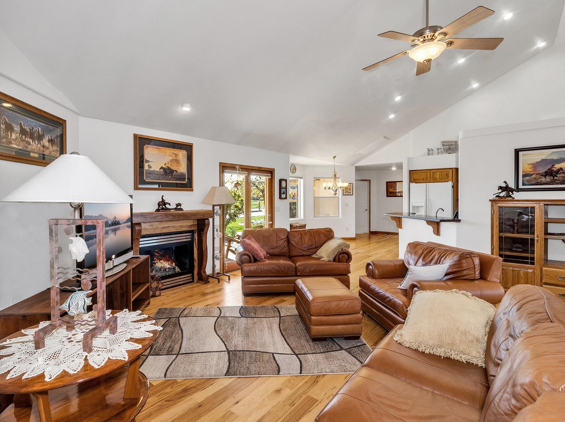2302 Outback Ridge Road Grand Junction, CO 81505 - Photo 22 of 42 a living room with furniture a fireplace and a flat screen tv