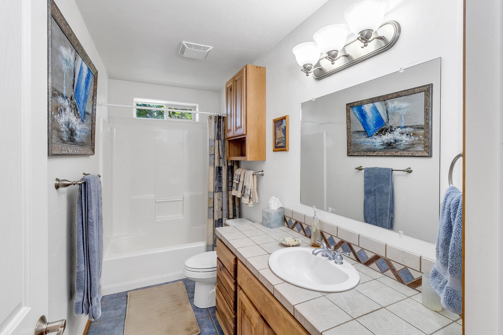 2302 Outback Ridge Road Grand Junction, CO 81505 - Photo 35 of 42 a bathroom with a granite countertop sink a toilet and a bathtub