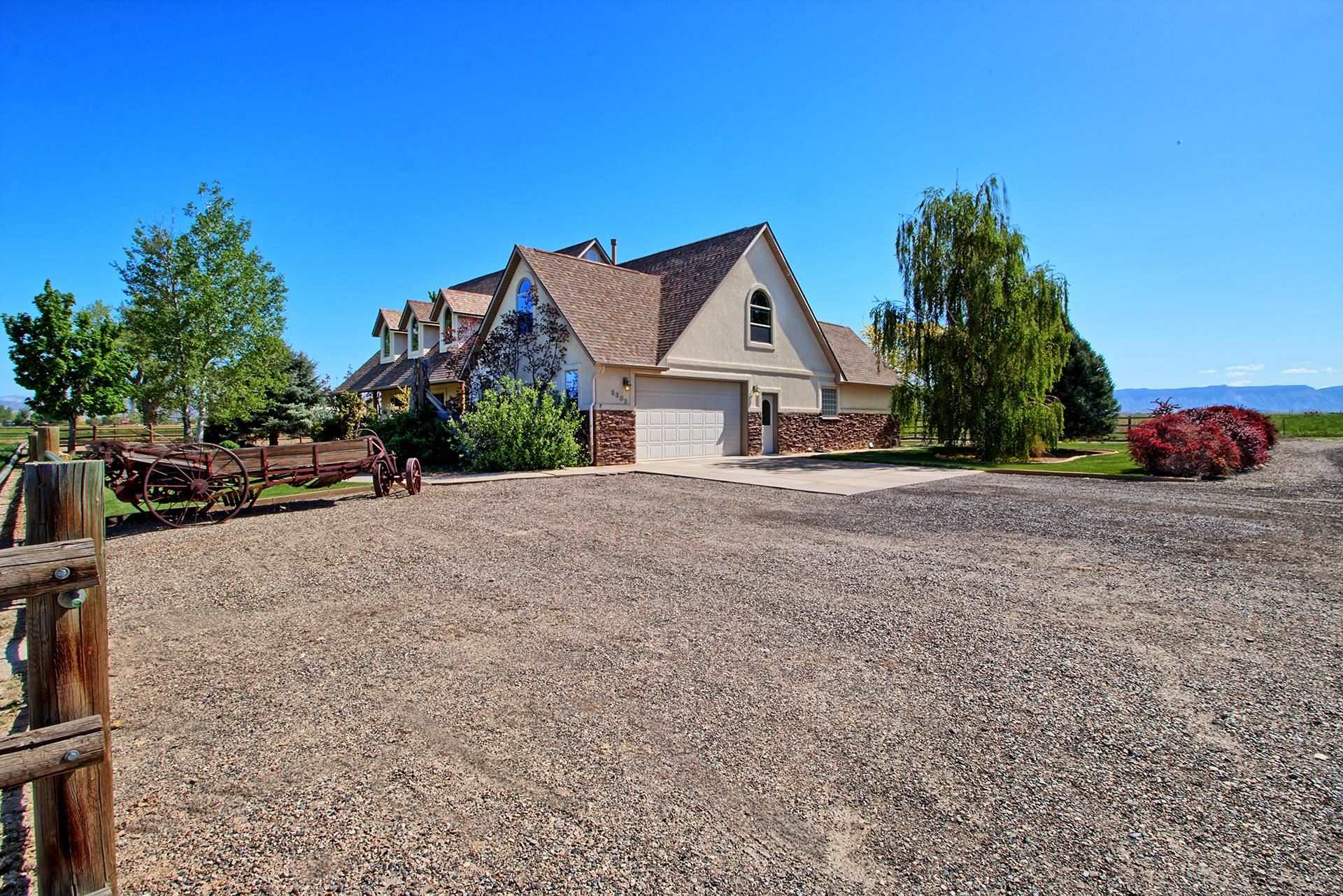 2302 Outback Ridge Road Grand Junction, CO 81505 - Photo 9 of 42 a front view of a house with a yard