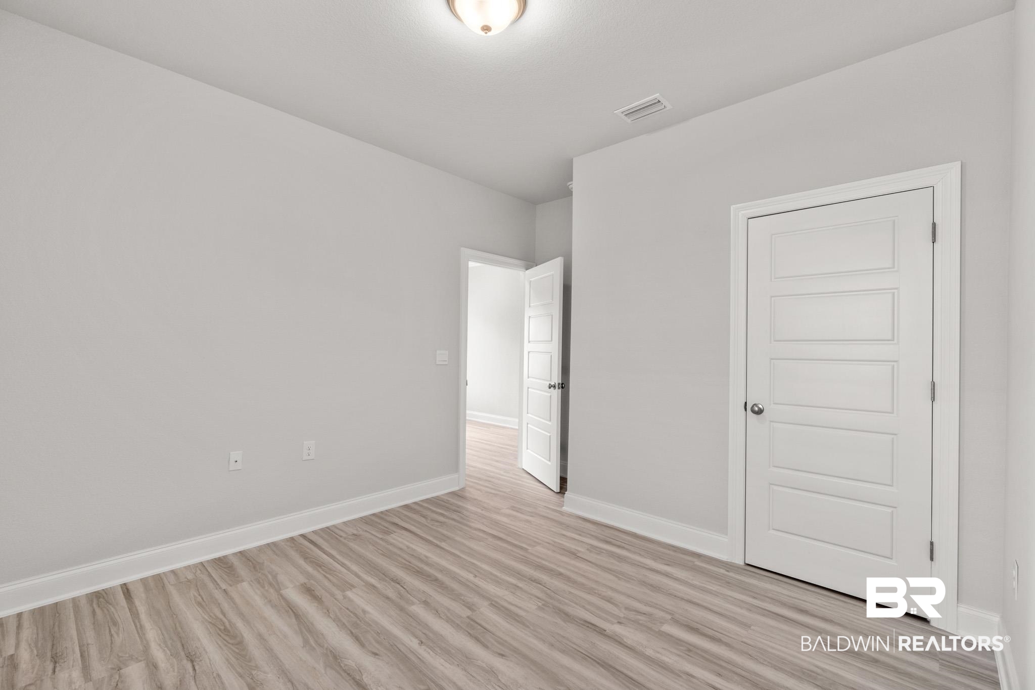 32125 Lyon Road Daphne, AL 36527 - Photo 33 of 70 Light gray wall finish with wood-finish flooring