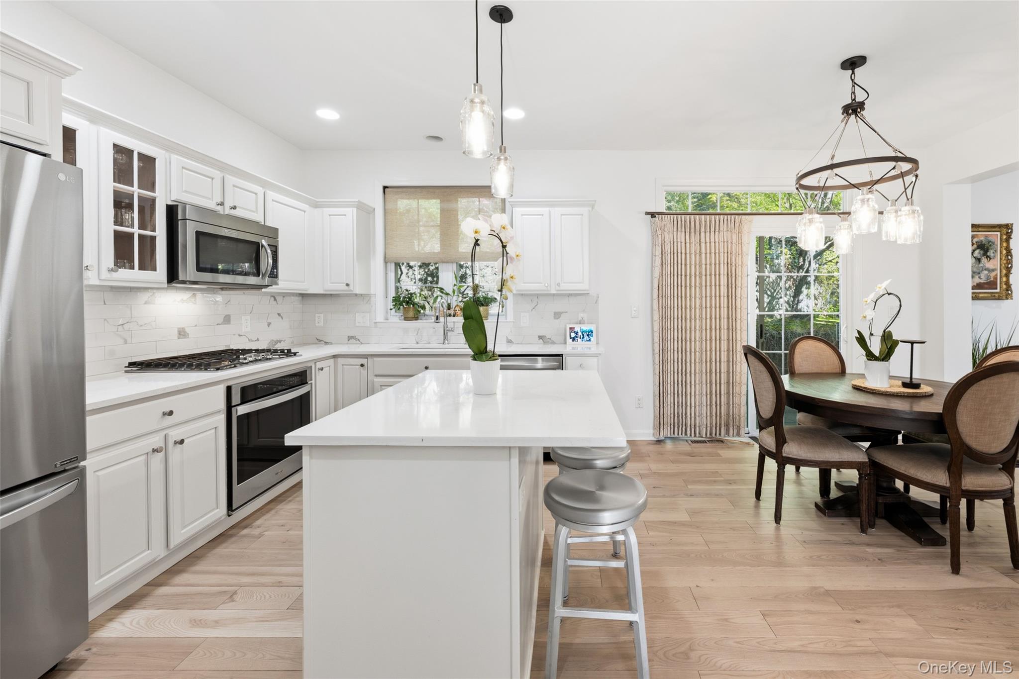 40 Bellefair Road Rye Brook, NY 10573 - Photo 10 of 43 Gourmet chef's kitchen highlighting the dining area and sliding glass doors that lead to the rear patio