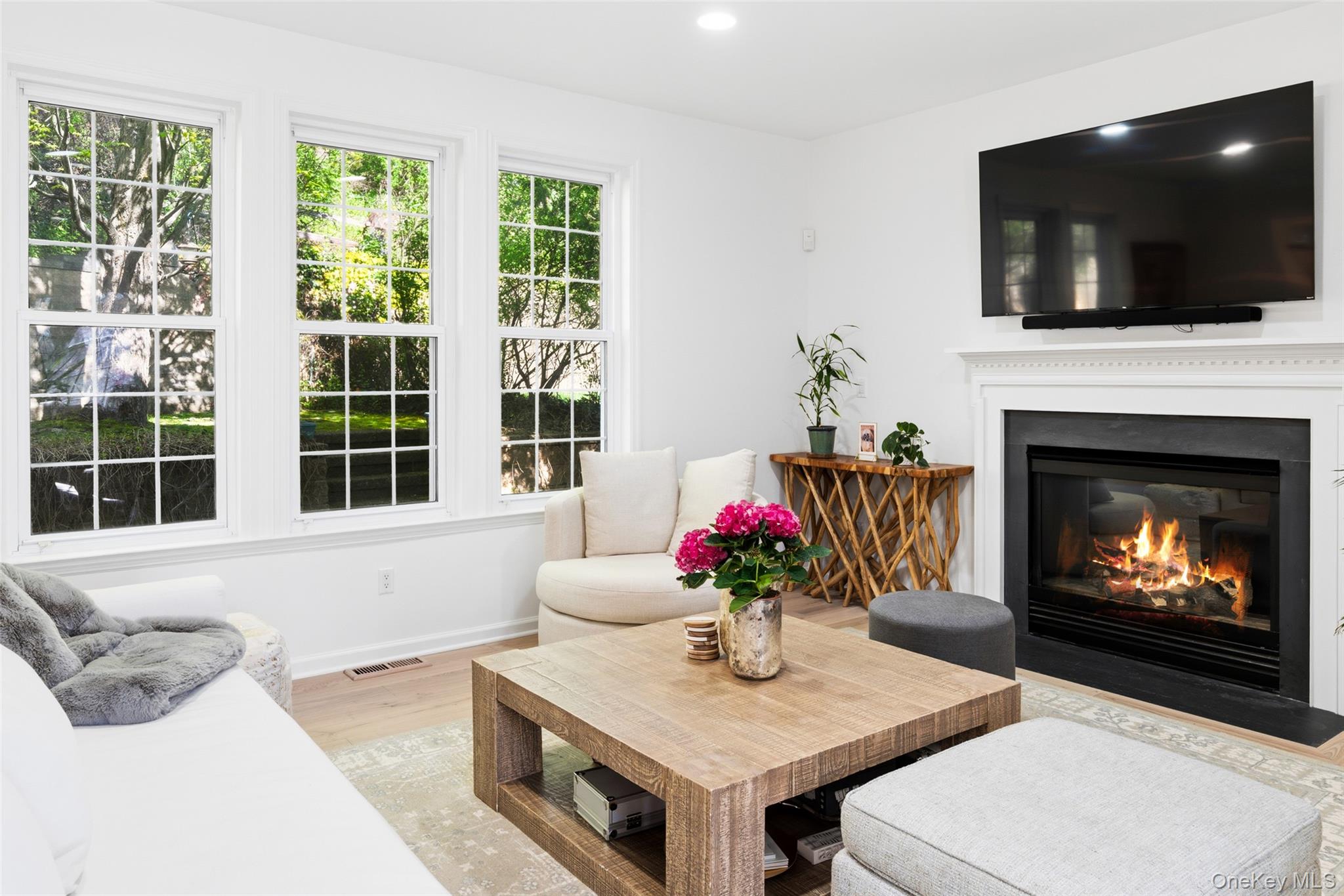 40 Bellefair Road Rye Brook, NY 10573 - Photo 16 of 43 Beautiful Family room with gas fireplace and walls of windows