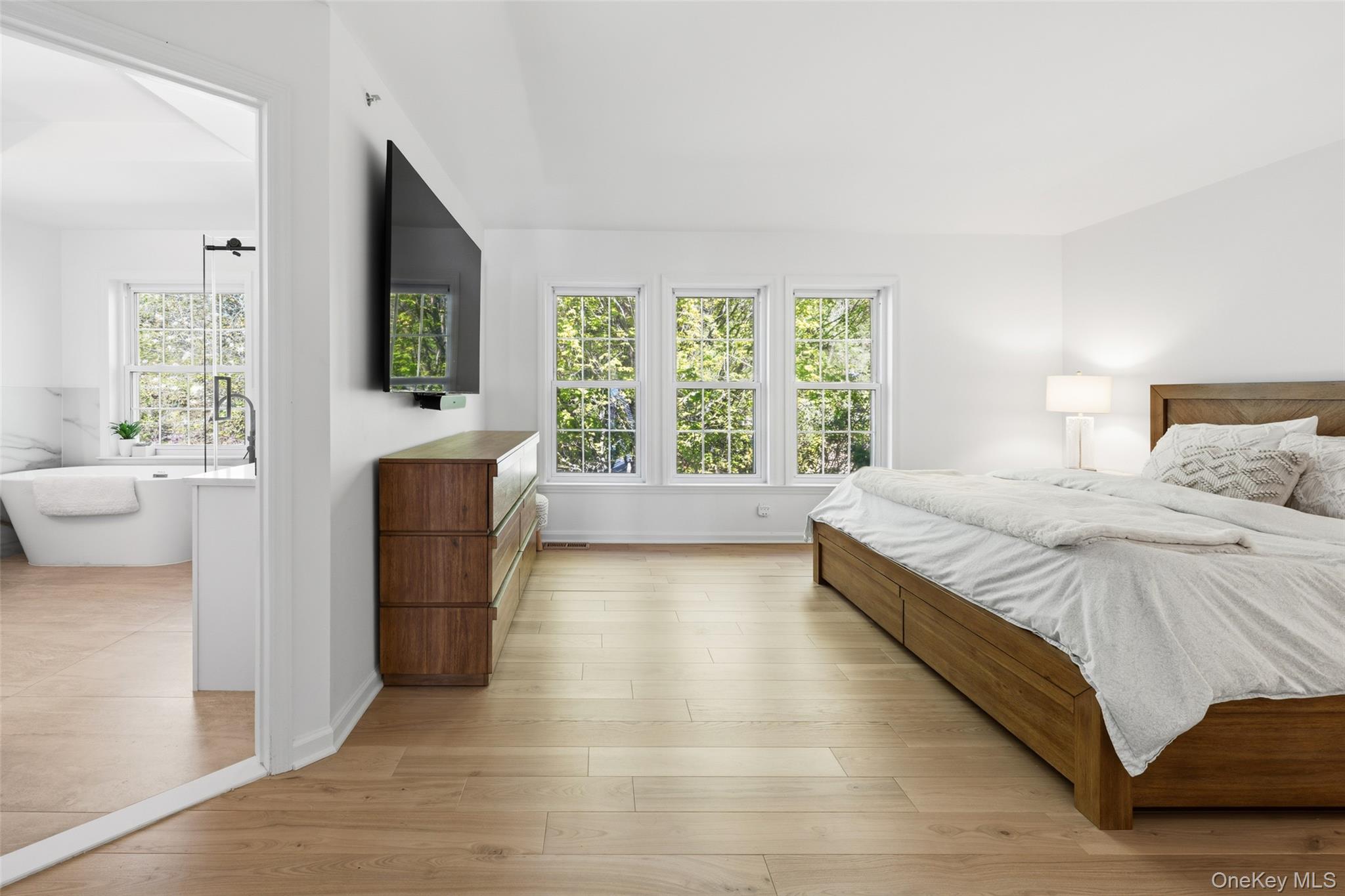 40 Bellefair Road Rye Brook, NY 10573 - Photo 19 of 43 Primary suite with walls of windows and beautiful hardwood floors, not seen is a huge walk in closet