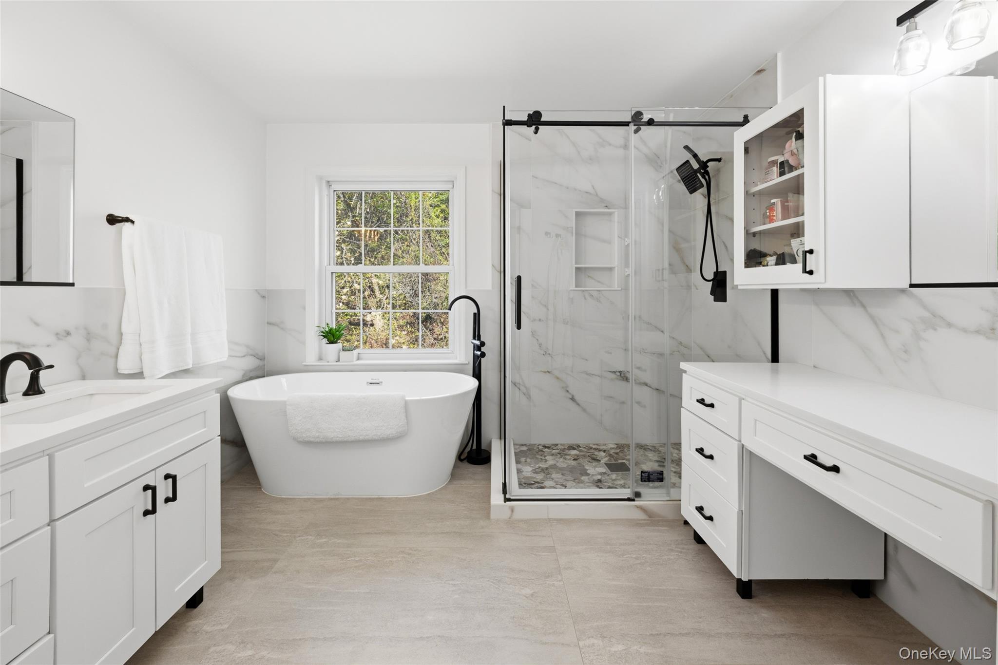 40 Bellefair Road Rye Brook, NY 10573 - Photo 22 of 43 Luxurious Primary en- suite bath equipped with a soaking tub and glass enclosed shower - double vanities and toilet room