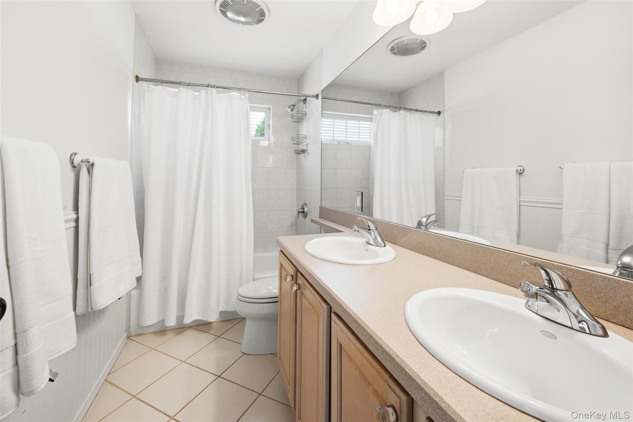 40 Bellefair Road Rye Brook, NY 10573 - Photo 26 of 43 Hall Bath featuring double vanities, shower- tub combination