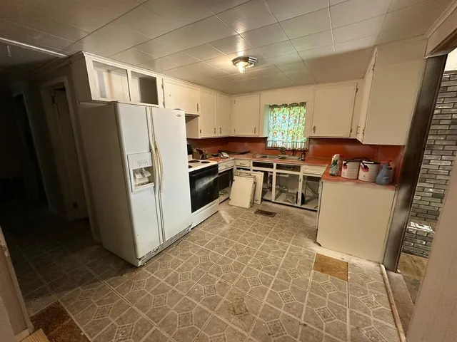 a kitchen with furniture a window and stainless steel appliances
