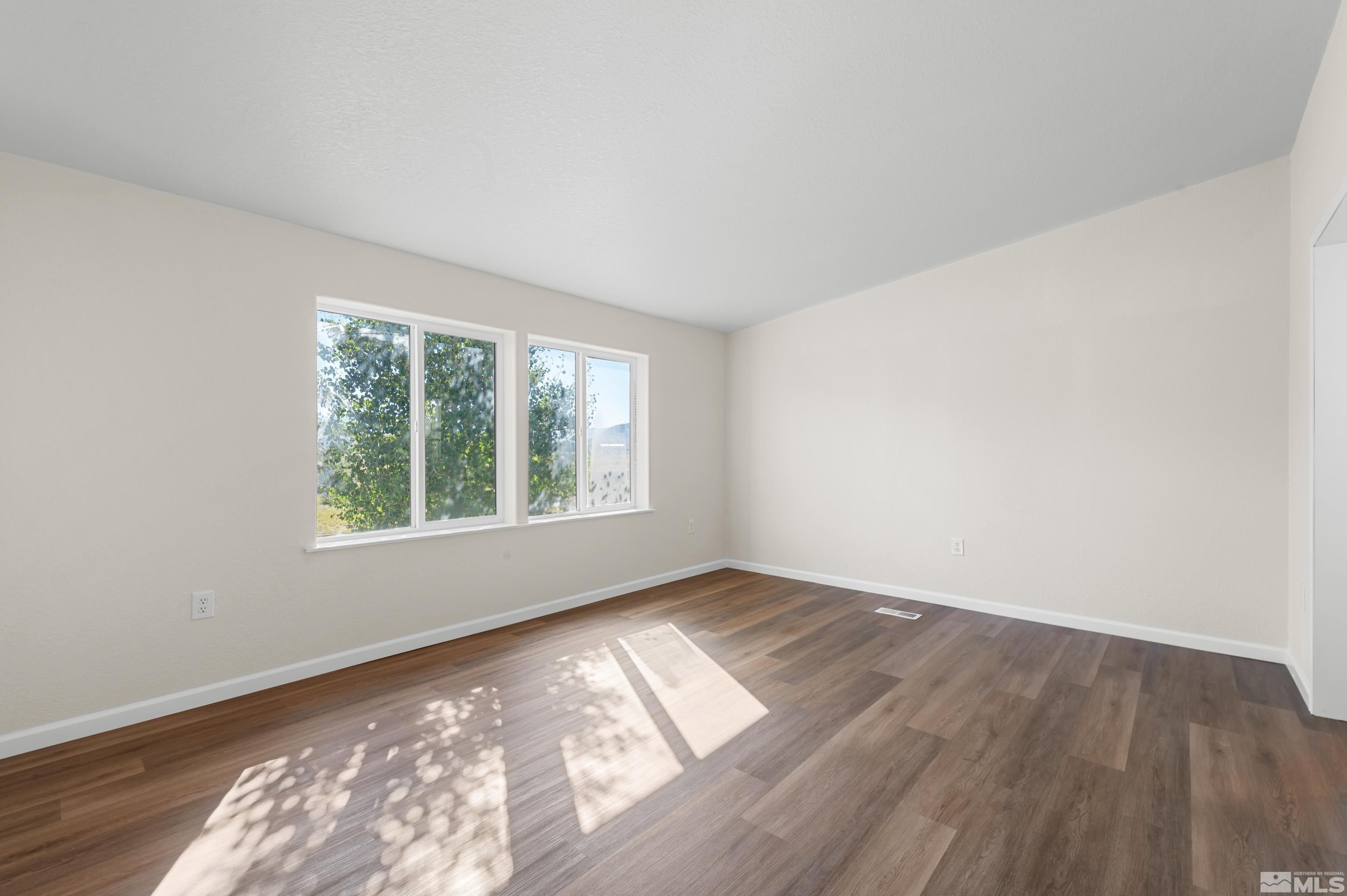 10 Rodeo Drive Reno, NV 89508 - Photo 14 of 37 an empty room with wooden floor and windows