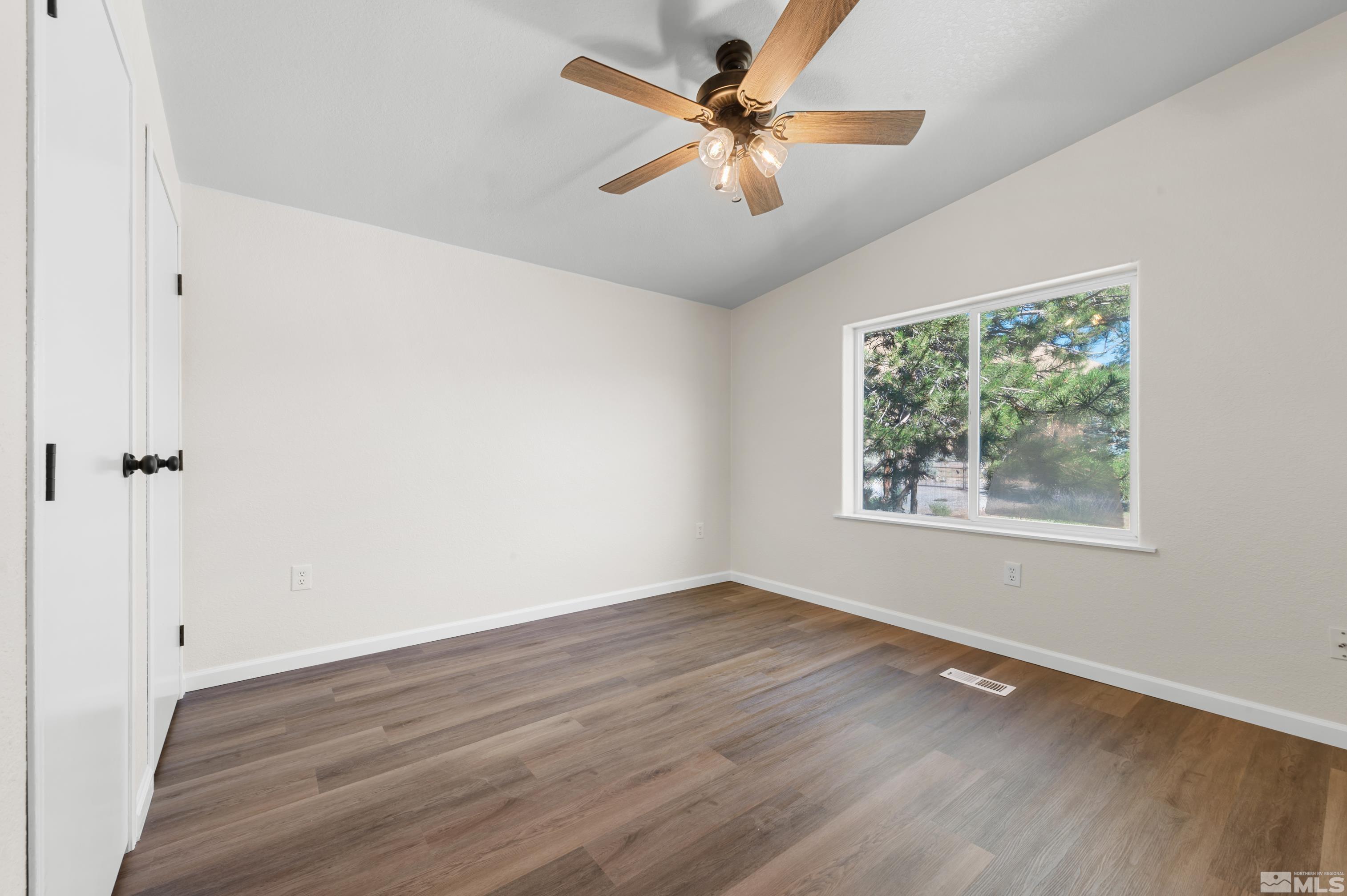 10 Rodeo Drive Reno, NV 89508 - Photo 19 of 37 a view of an empty room with wooden floor and a window