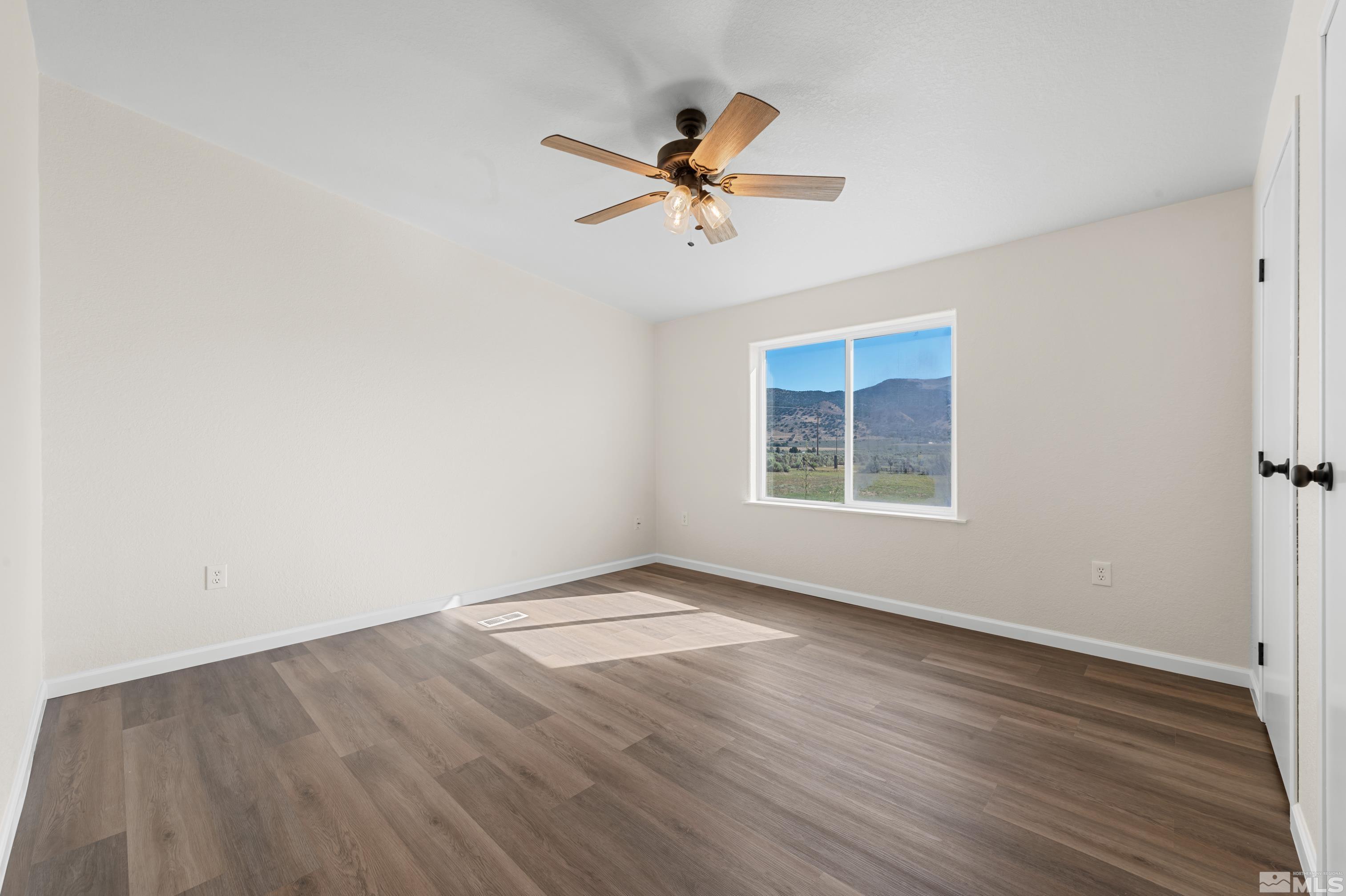 10 Rodeo Drive Reno, NV 89508 - Photo 21 of 37 a view of empty room with wooden floor and fan