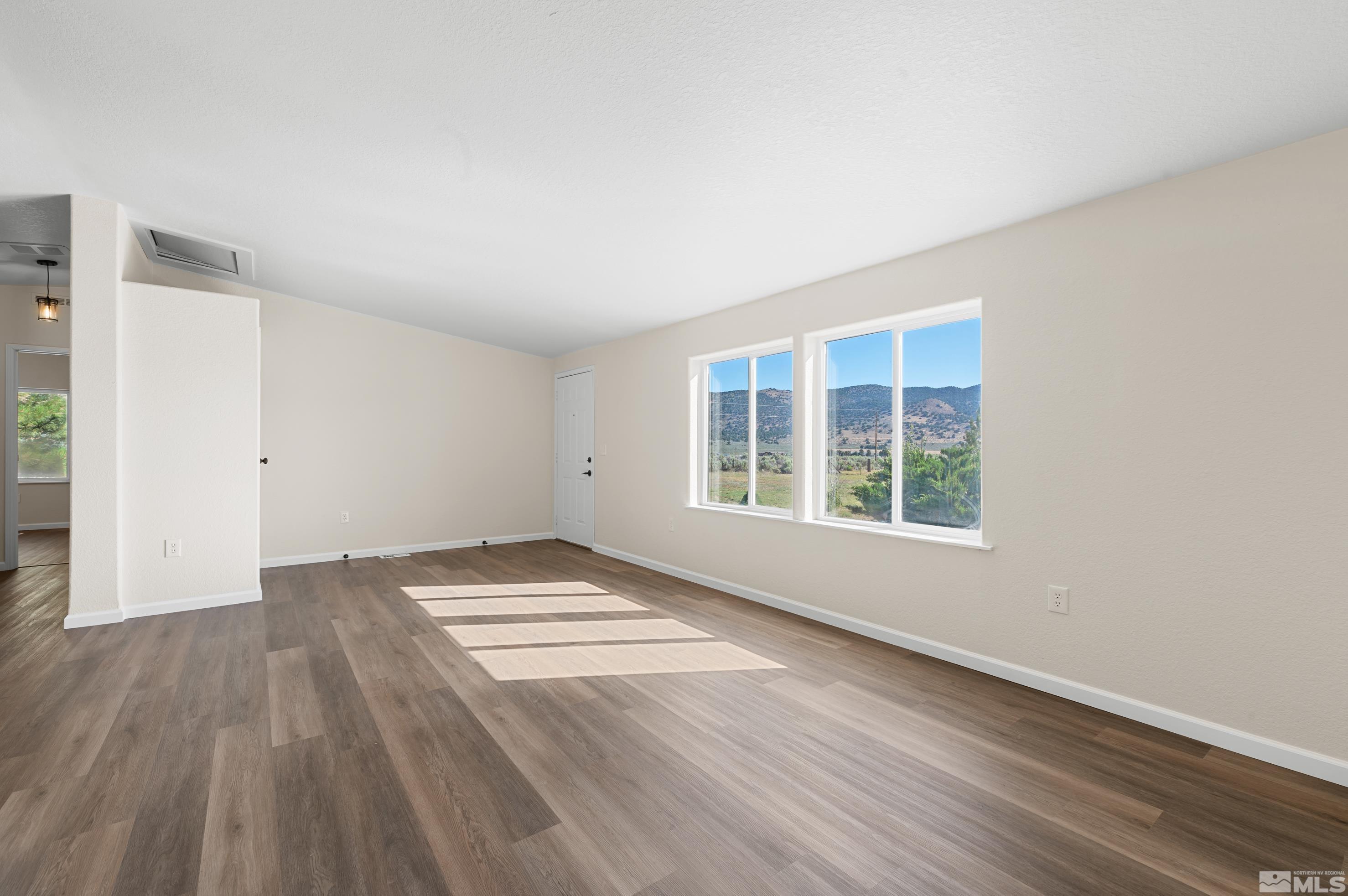 10 Rodeo Drive Reno, NV 89508 - Photo 5 of 37 an empty room with wooden floor and windows