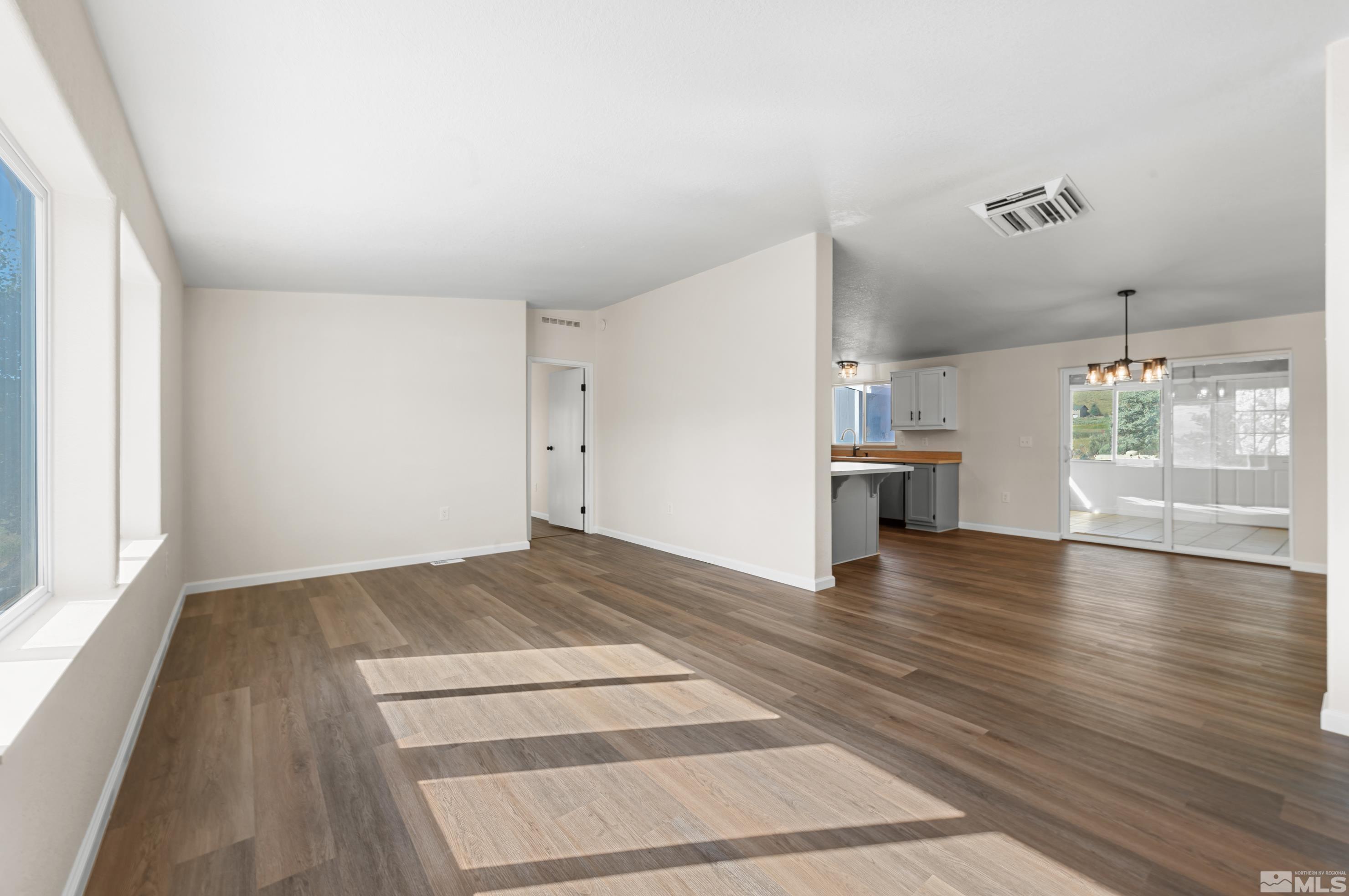 10 Rodeo Drive Reno, NV 89508 - Photo 6 of 37 a view of empty room with wooden floor and windows