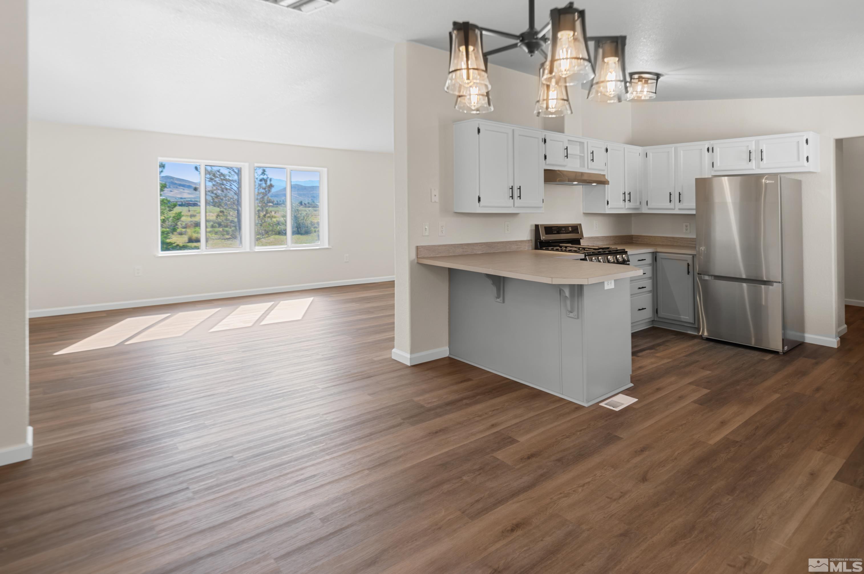 10 Rodeo Drive Reno, NV 89508 - Photo 7 of 37 a kitchen with stainless steel appliances a stove top oven and a refrigerator