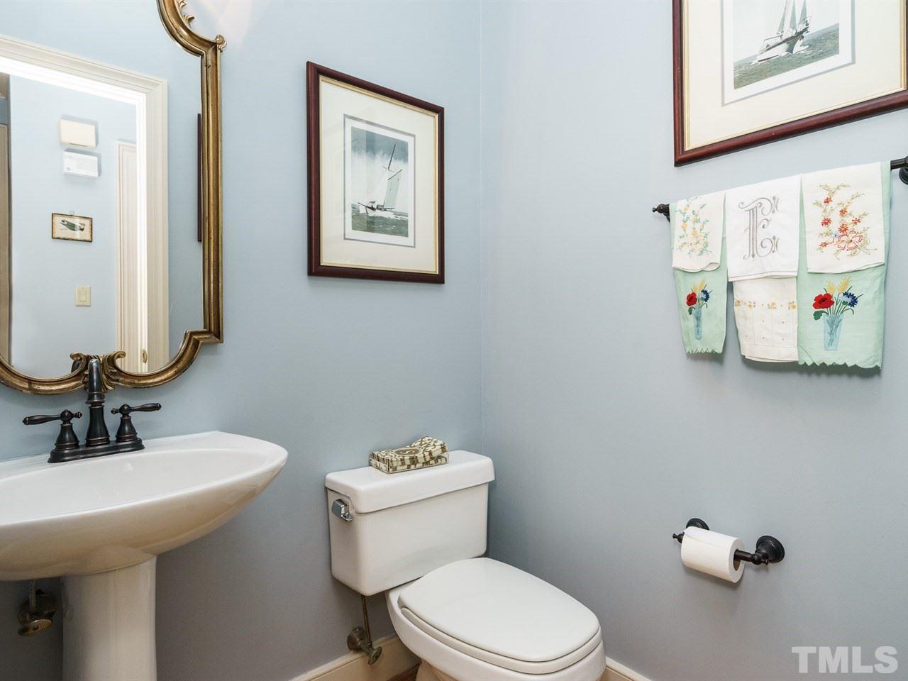 3100 White Oak Road Raleigh, NC 27609 - Photo 14 of 25 a bathroom with a toilet sink and mirror