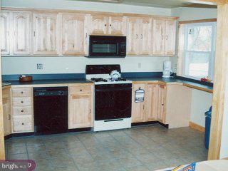 12420 Sweet Briar Road Philadelphia, PA 19154 - Photo 2 of 4 a kitchen with stainless steel appliances granite countertop a stove and a microwave