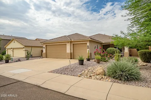 a front view of a house with a garden and pathway