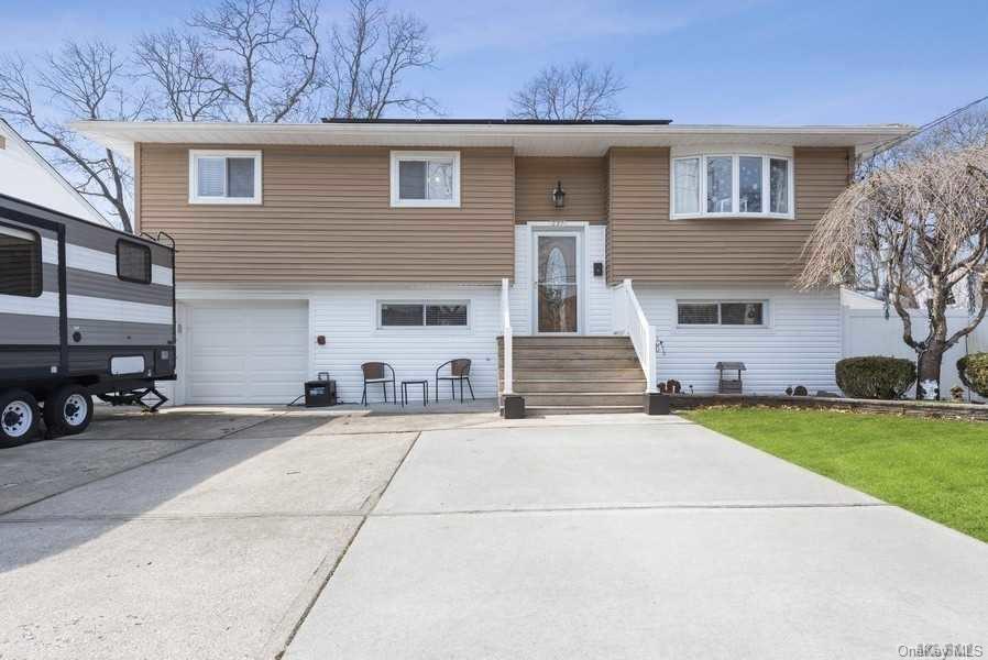 a view of a house with a yard and garage