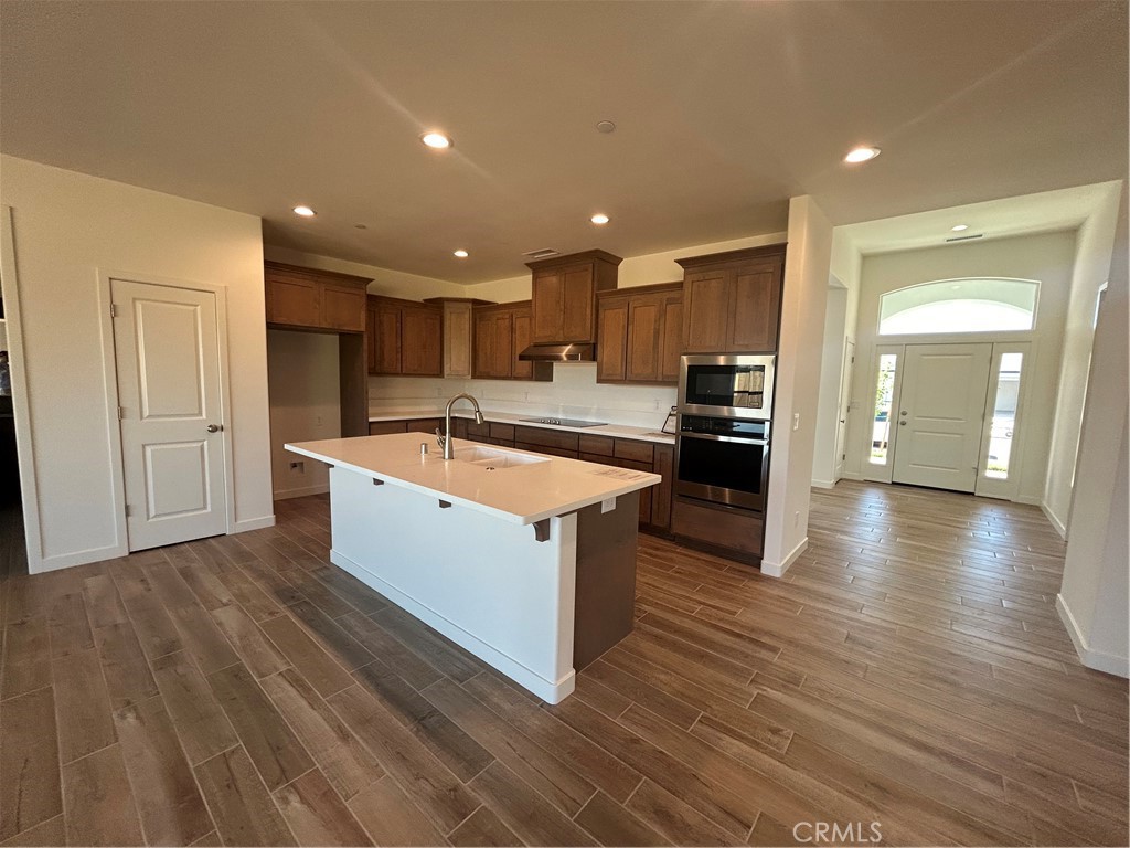 325 Bainbridge Place Chico, CA 95973 - Photo 14 of 26 a large kitchen with stainless steel appliances granite countertop a large counter top and wooden floors