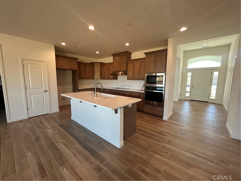 325 Bainbridge Place Chico, CA 95973 - Photo 15 of 26 a large kitchen with stainless steel appliances granite countertop a large counter top and wooden floors
