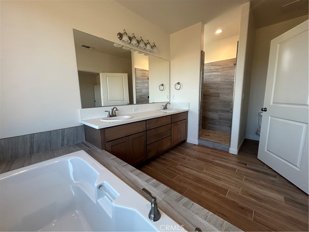 325 Bainbridge Place Chico, CA 95973 - Photo 23 of 26 a spacious bathroom with a double vanity sink a large mirror and a shower