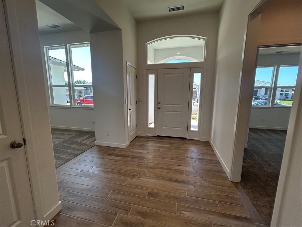 325 Bainbridge Place Chico, CA 95973 - Photo 4 of 26 an empty room with wooden floor and windows