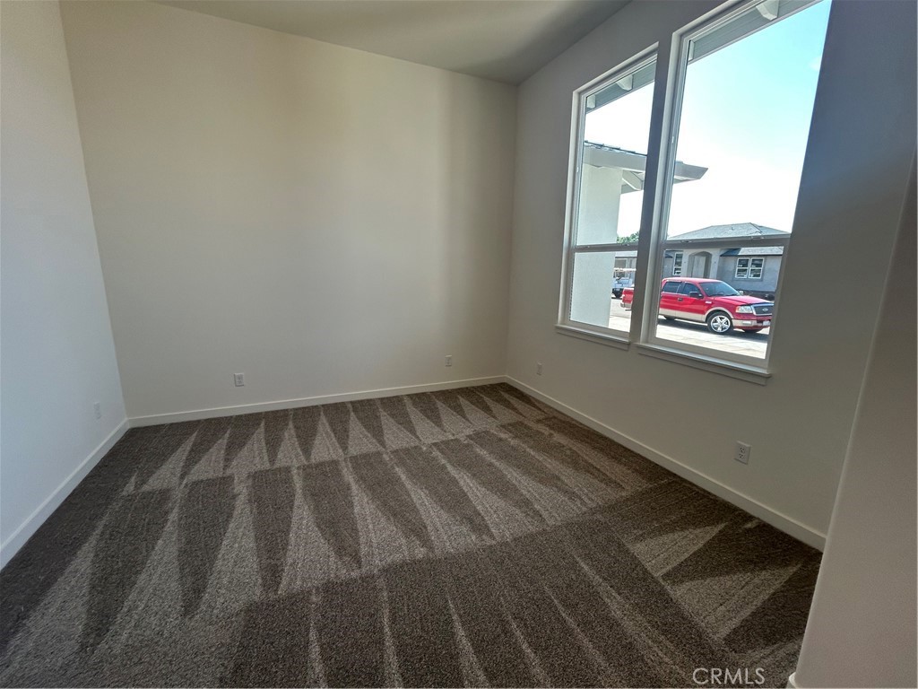 325 Bainbridge Place Chico, CA 95973 - Photo 5 of 26 an empty room with wooden floor and windows