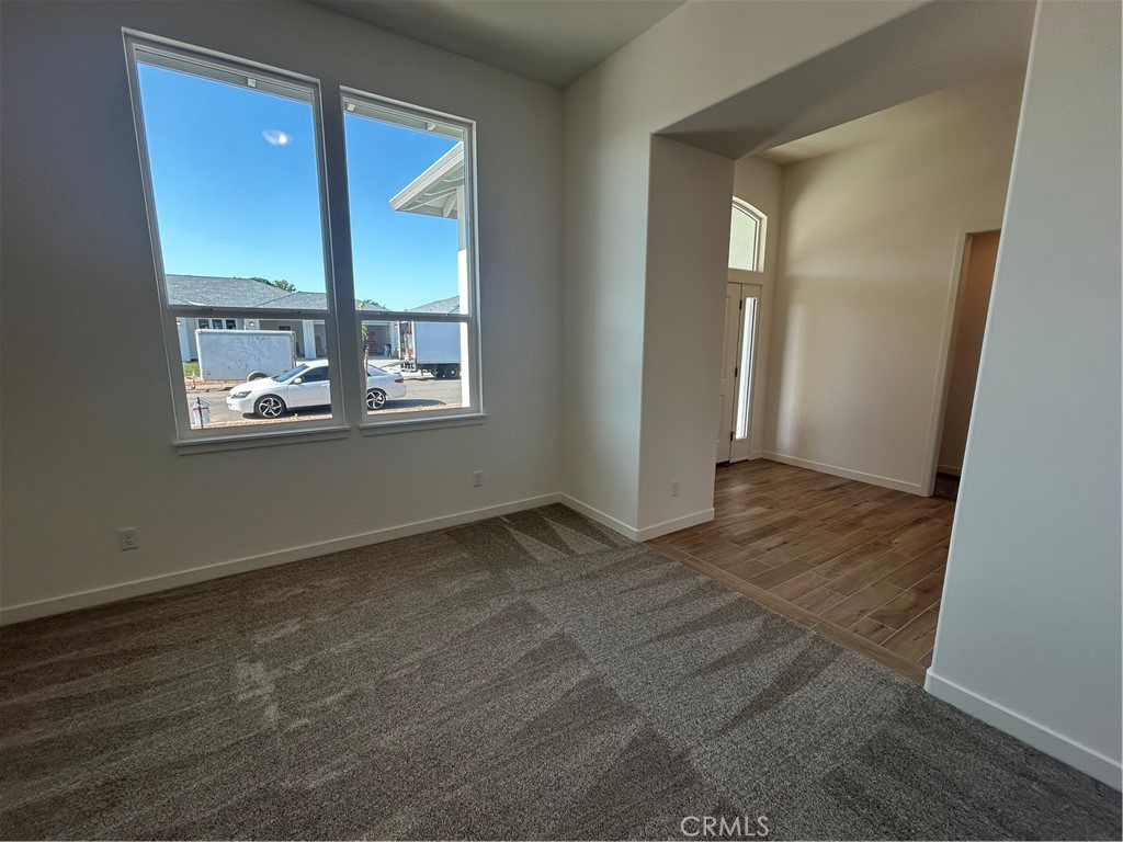 325 Bainbridge Place Chico, CA 95973 - Photo 7 of 26 an empty room with wooden floor and windows