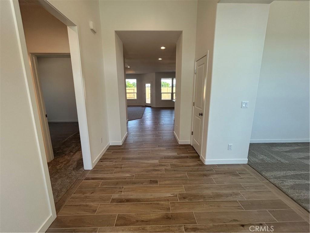325 Bainbridge Place Chico, CA 95973 - Photo 10 of 26 a view of a hallway with wooden floor and staircase