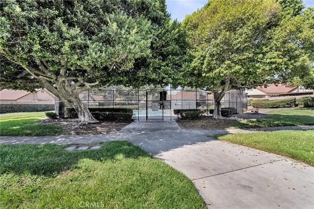 a view of a swimming pool with a patio and a yard