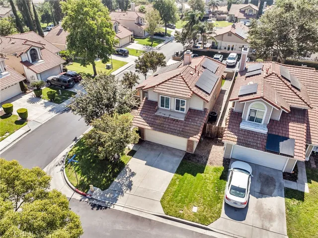 an aerial view of a house with a yard