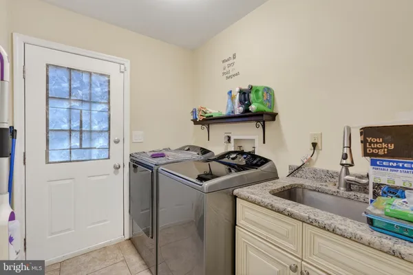 a kitchen with granite countertop a sink stove and cabinets