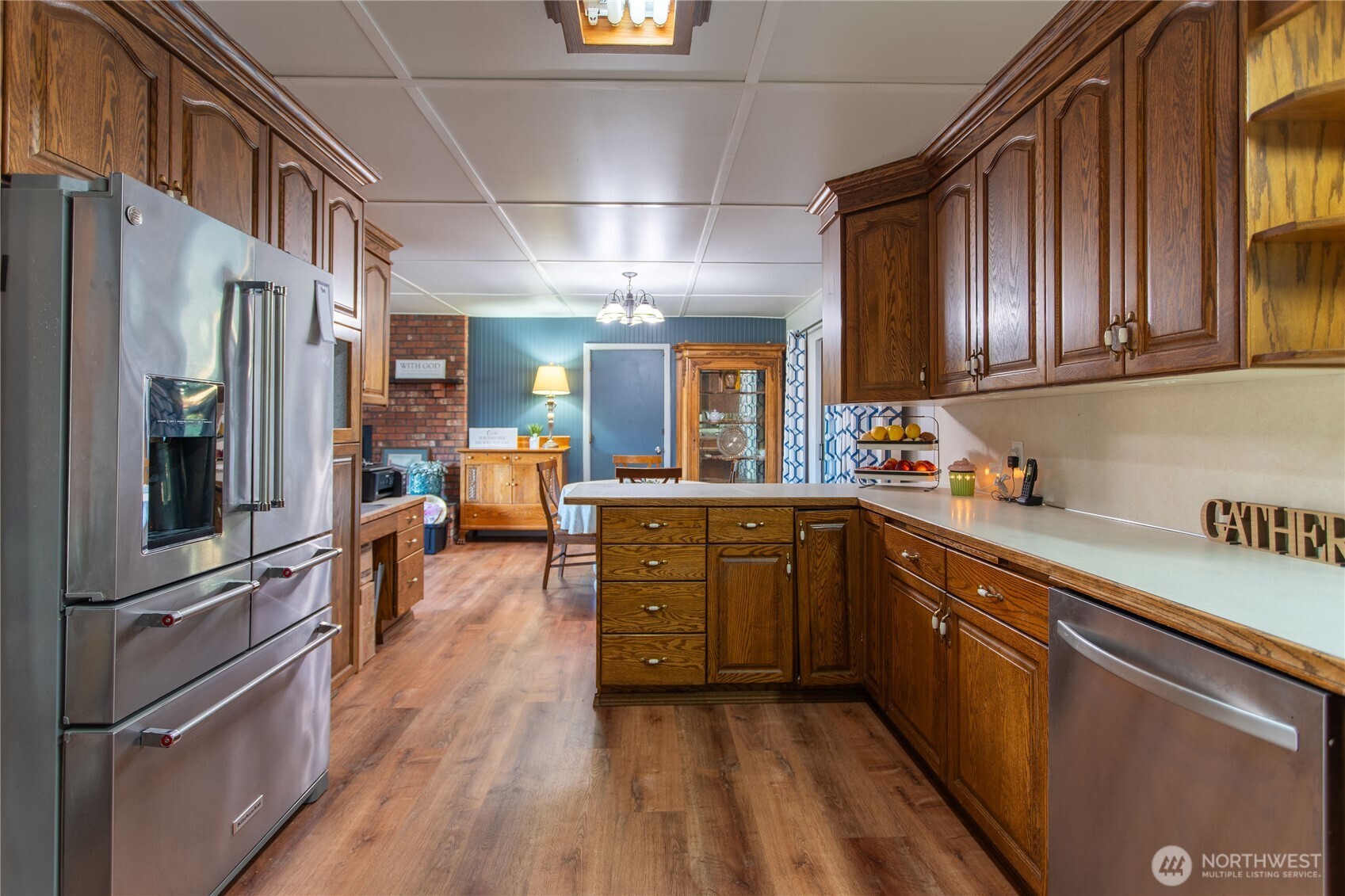 371 Pigeon Springs Road Onalaska, WA 98570 - Photo 9 of 39 a kitchen with stainless steel appliances granite countertop a refrigerator a sink dishwasher a stove and white countertops with wooden floor