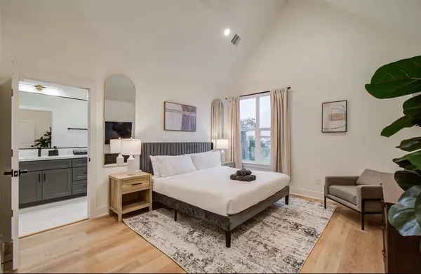 a spacious bedroom with a bed and a couch